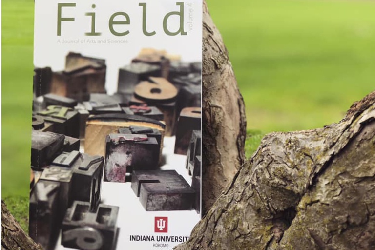The field magazine up against a tree.